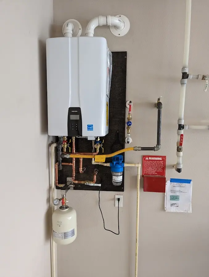 Professional plumber installing copper piping in a Constantine home